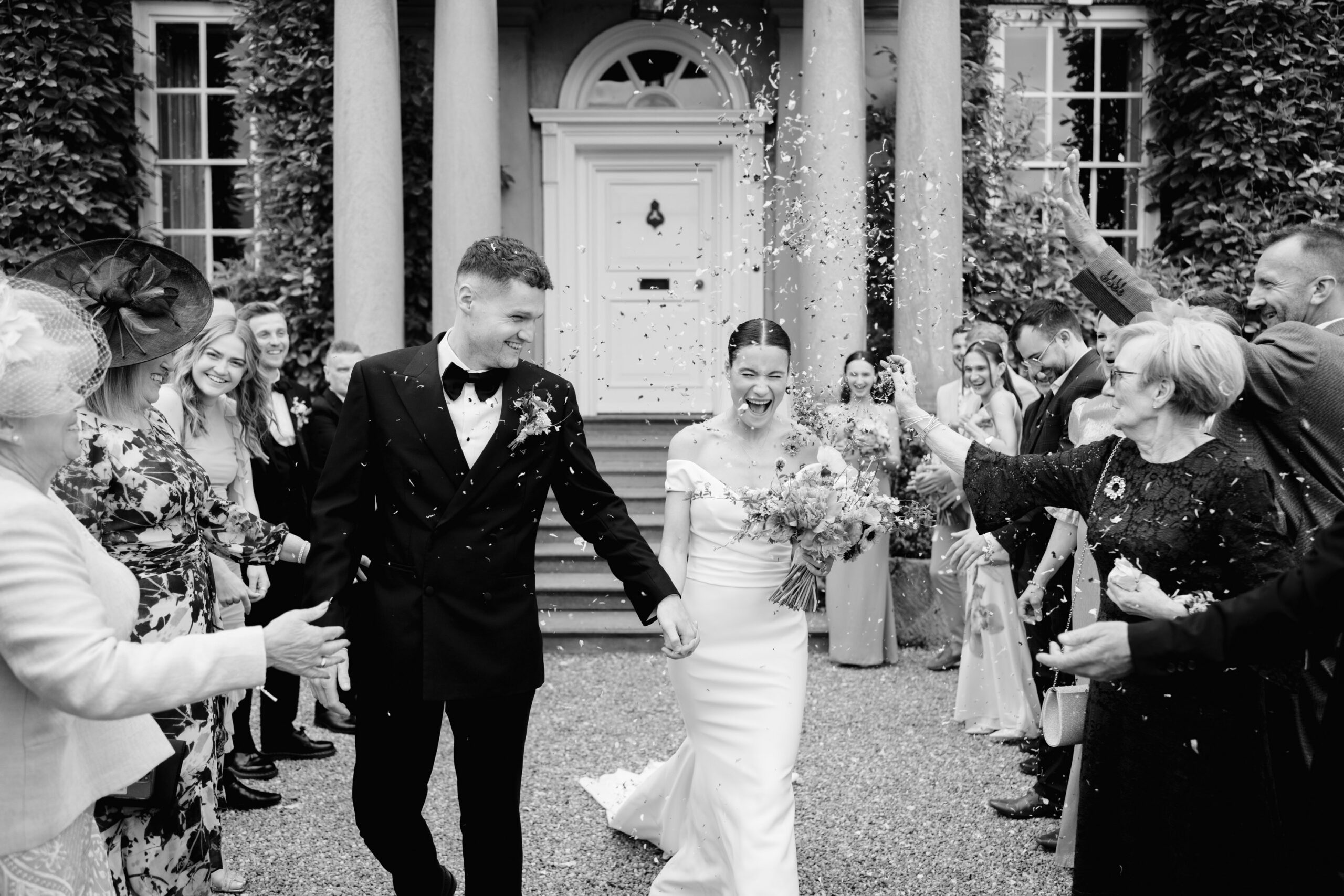 bride and groom walking through confetti at iscoyd park